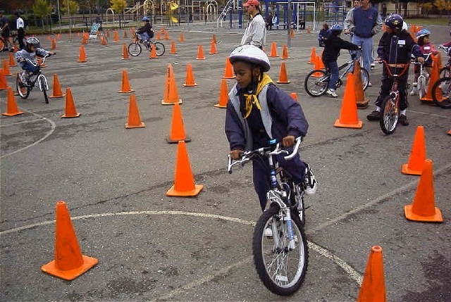 kid on a bike navigating cones