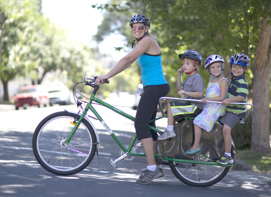 Women on cargo bike with three kids