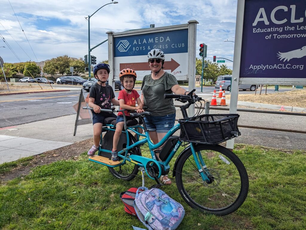 Woman riding bunch bike with kids